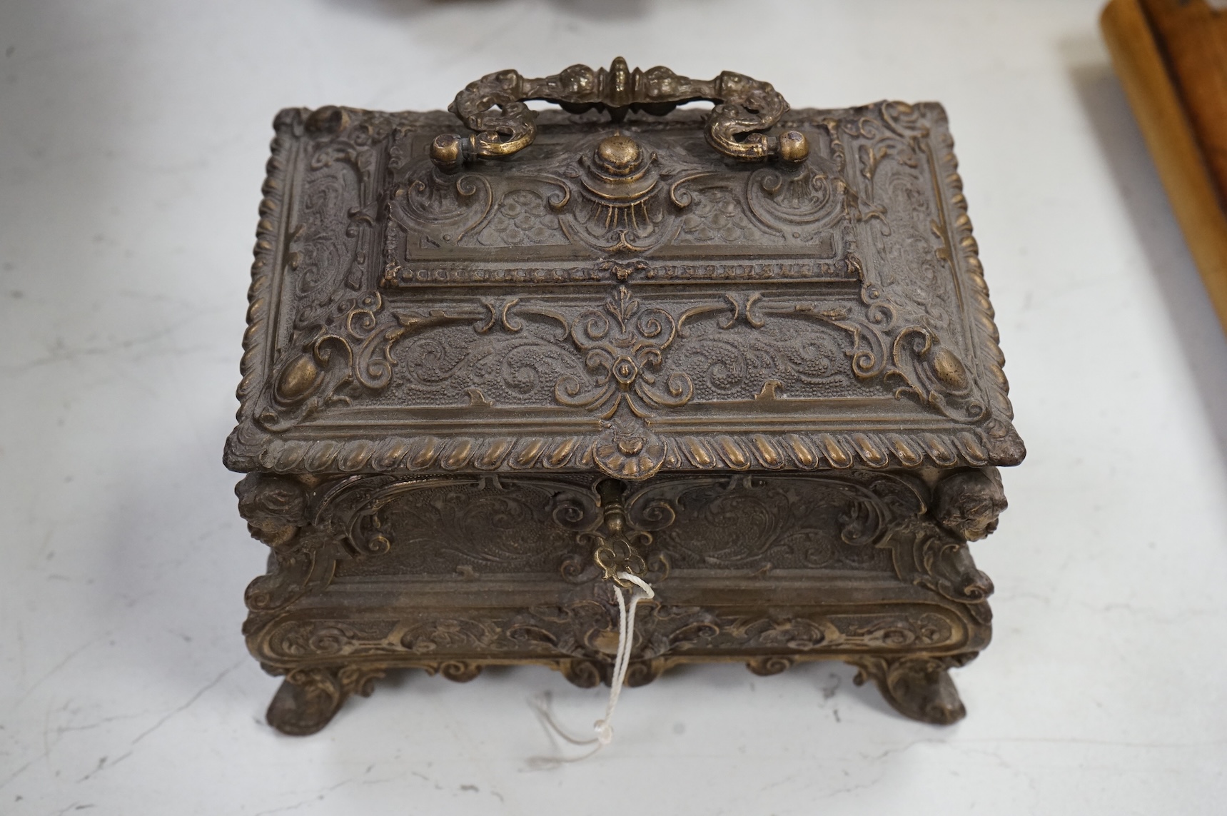 A rococo-style rectangular bronze casket and key, 17cm wide